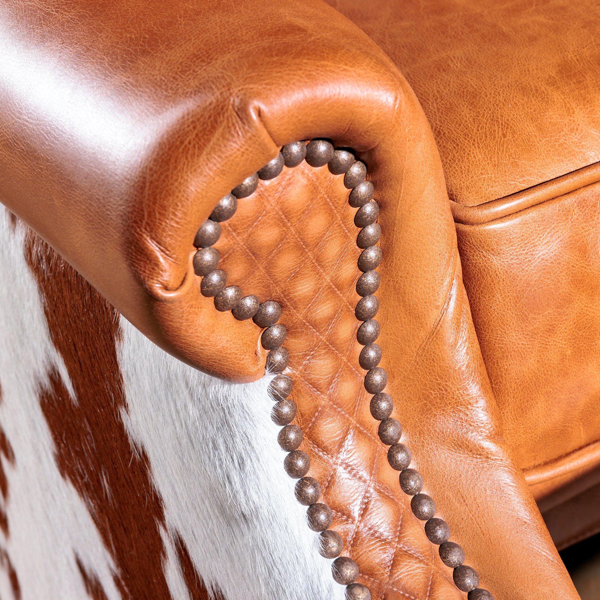 Detail view of the western leather cowhide recliner nailhead detail