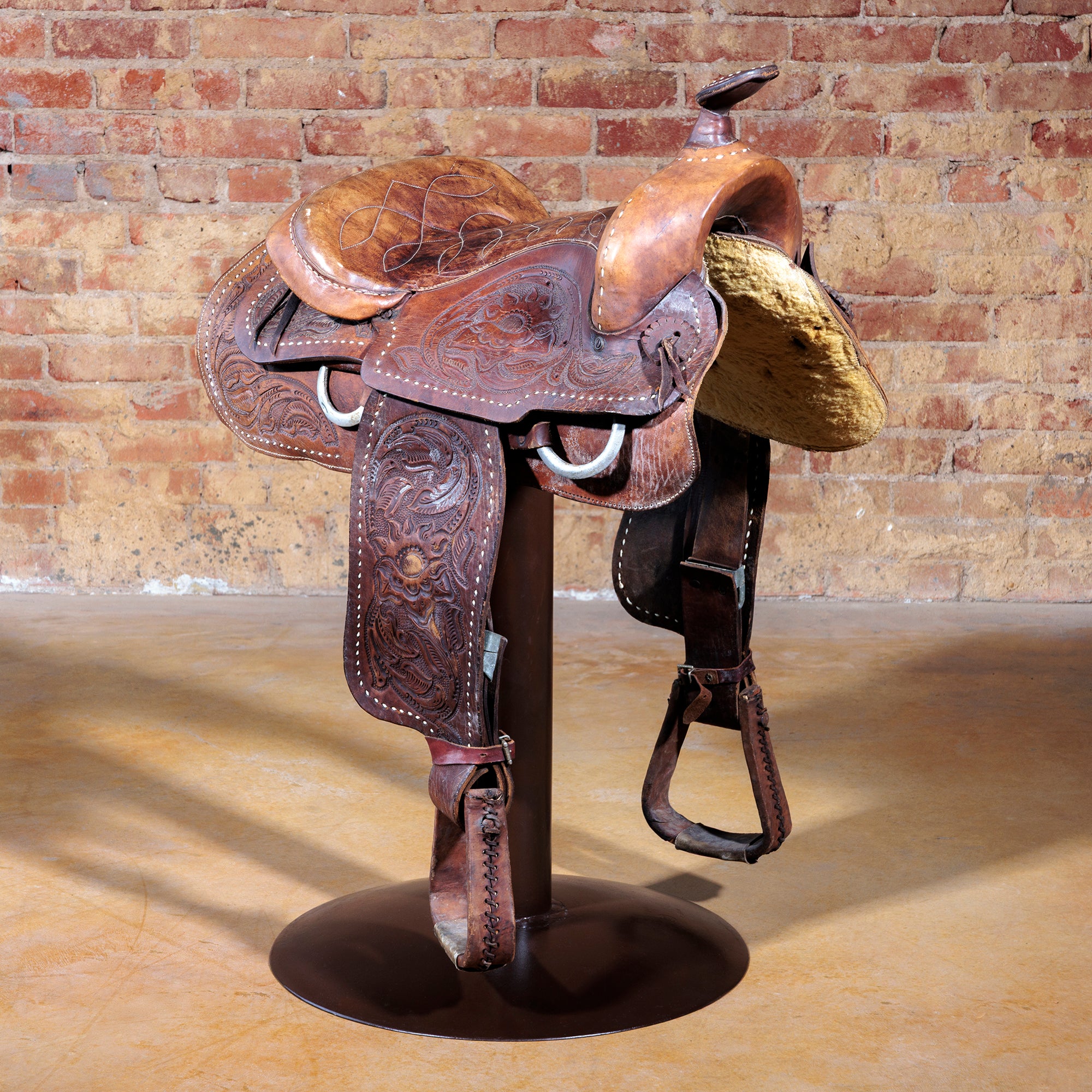 Rustic Western saddle bar stool with authentic leather saddle and solid steel base.