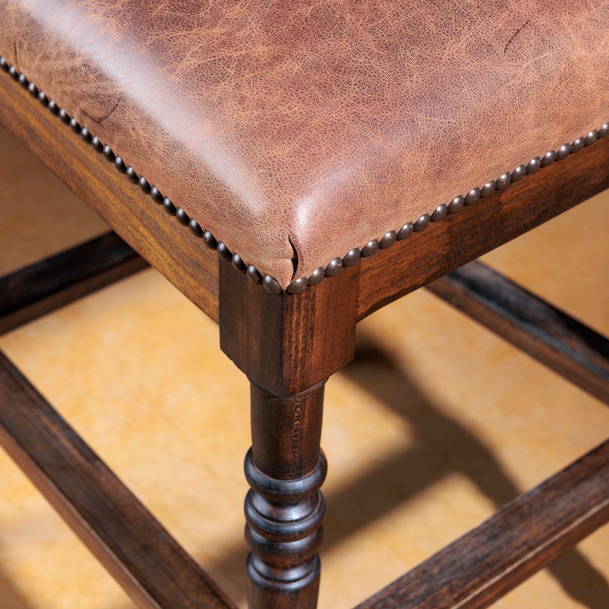 Close-up of tufted top-grain leather backrest on Longhorn Heritage Western bar stool