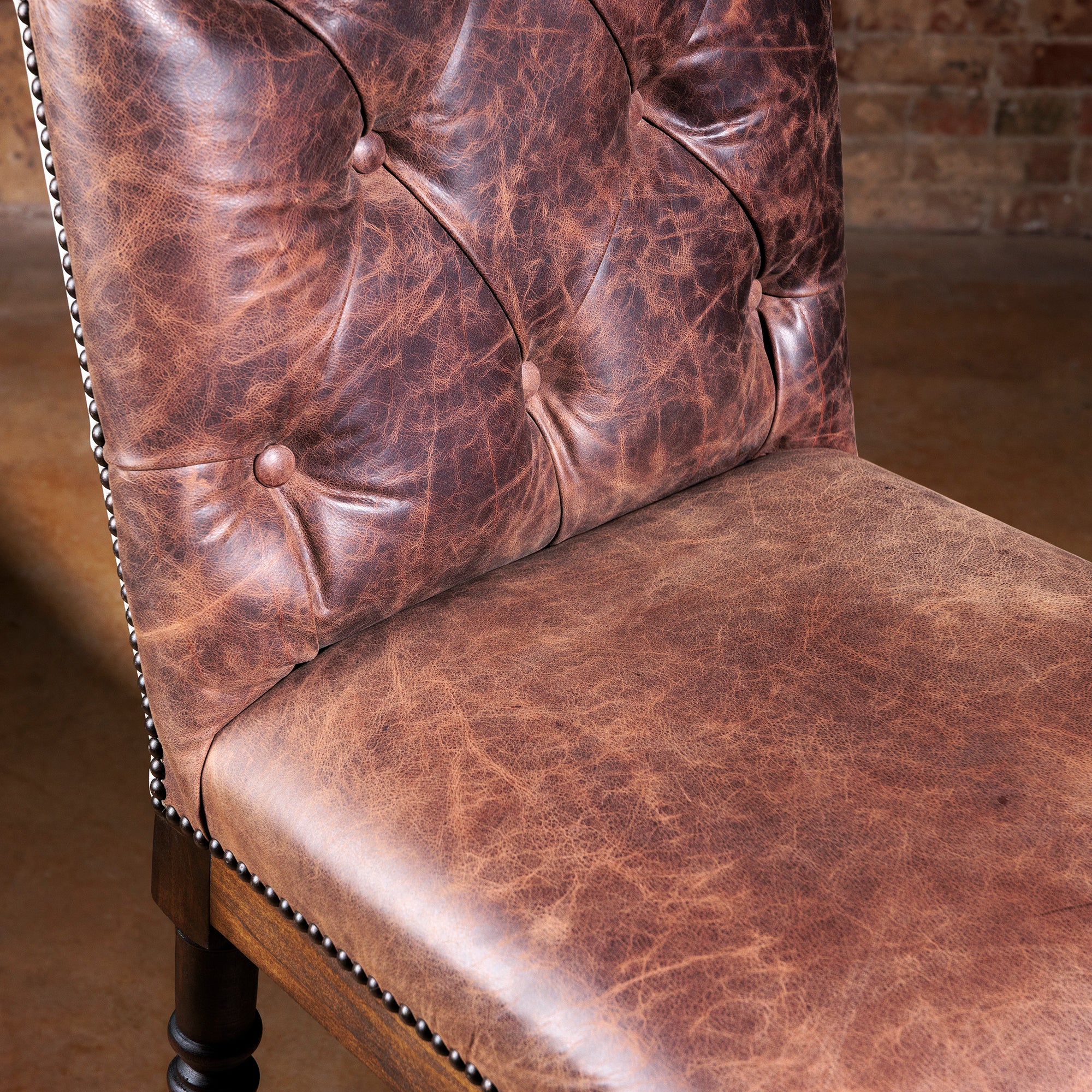 Close-up of tufted top-grain leather backrest on Longhorn Heritage Western bar stool