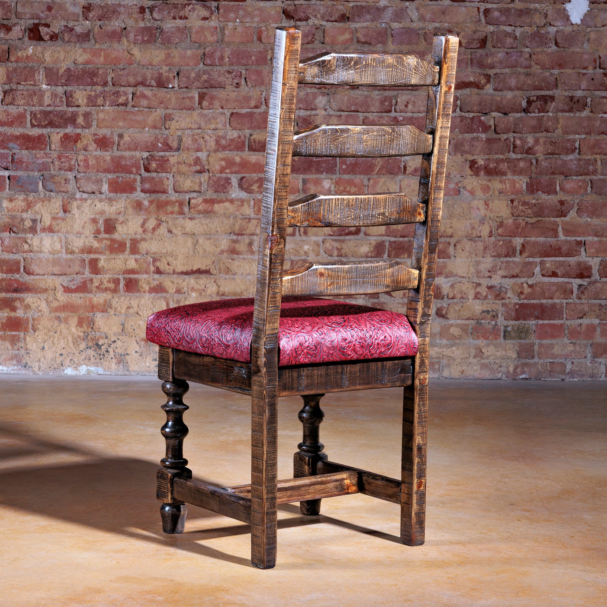 Back view of Western ladderback dining chair with red tooled leather seat