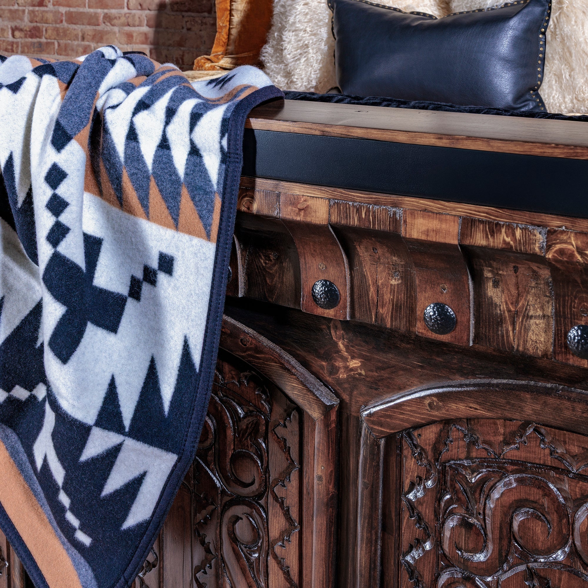 The Ironwood Carved Bed made from reclaimed wood with iron banding and hand-carved panels