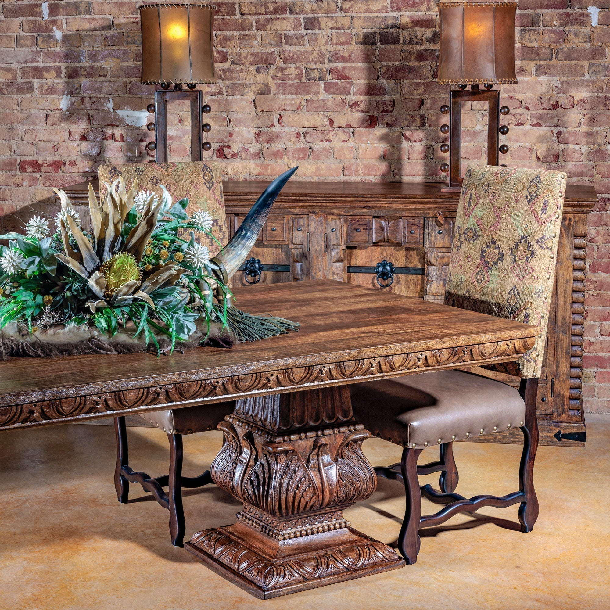 Western holiday dining table with copper chargers, hide runner, silverware, and seasonal greenery centerpiece