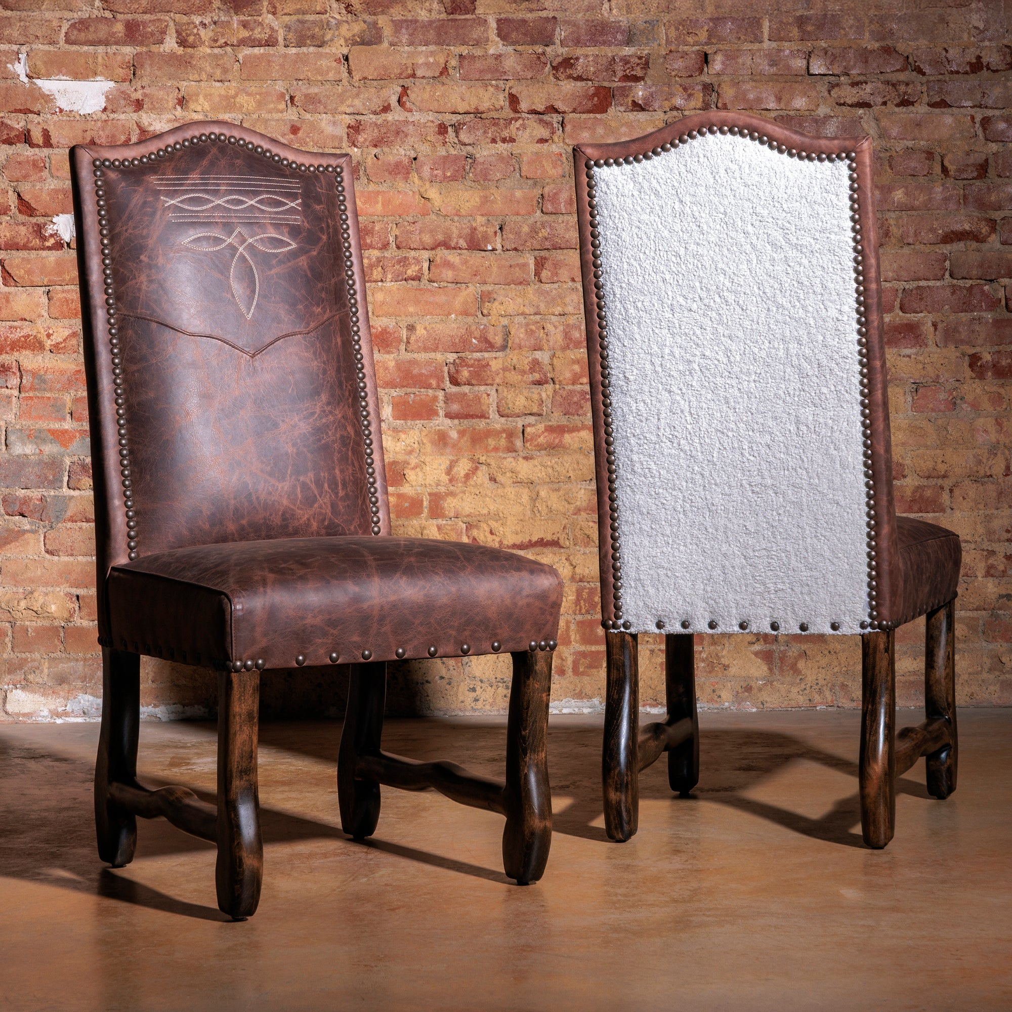 Handcrafted Western dining chairs with leather and cowhide upholstery in a rustic ranch-style dining room