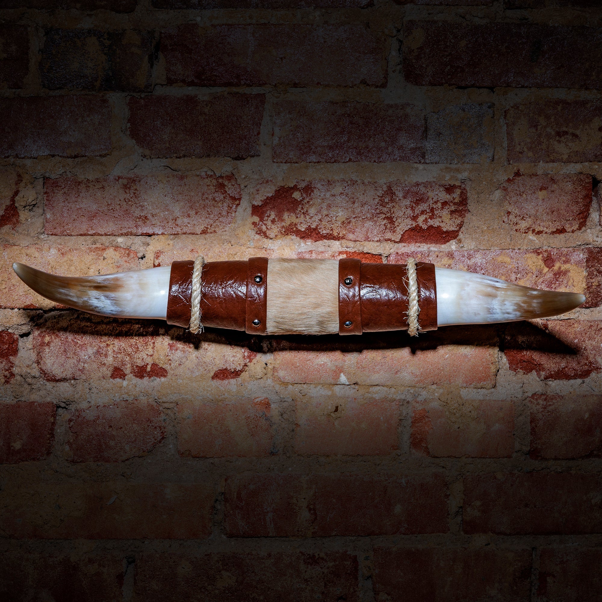 Wall-mounted Western horn decor featuring handcrafted longhorn and bull horn mounts with leather and natural finishes