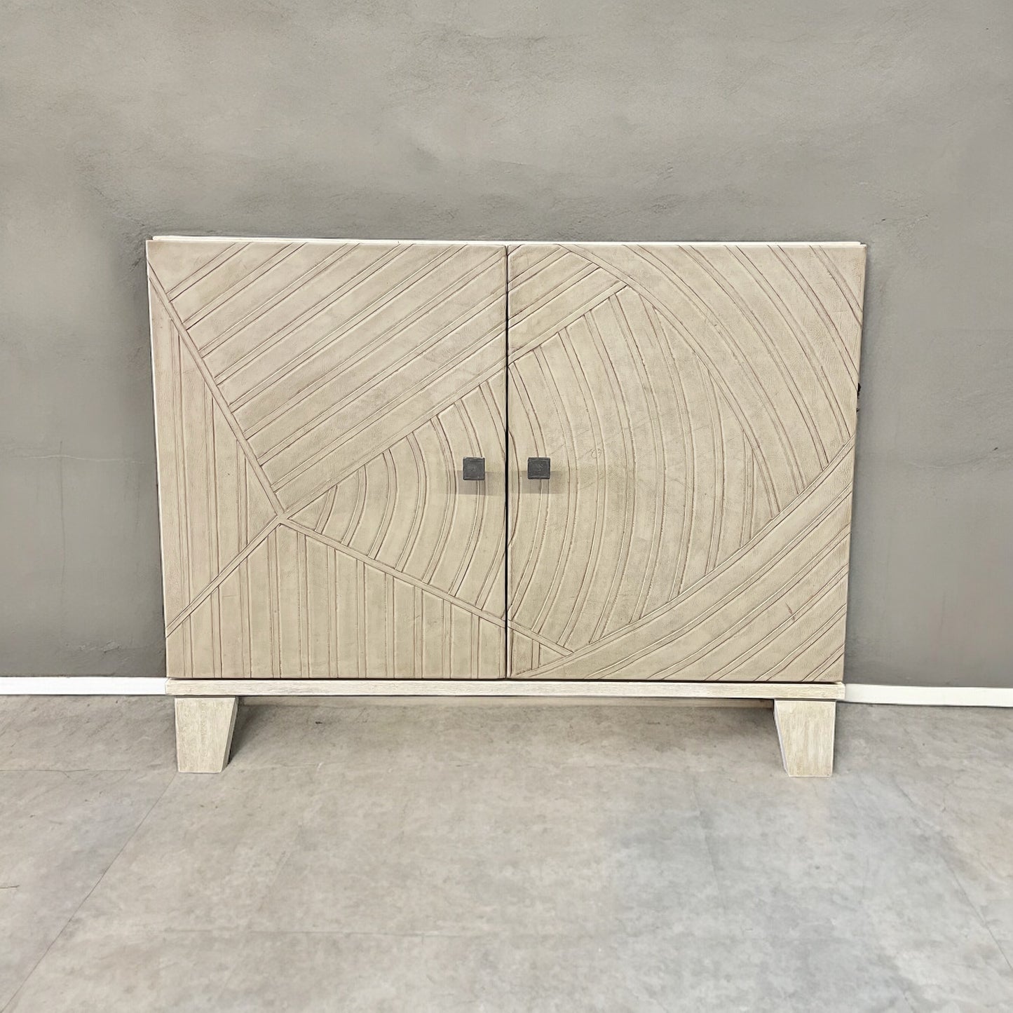 Introducing the Angella 2 Door Buffet, a timeless blend of western and modern design. Crafted from wood, the intricate carved doors add a touch of elegance to any dining room. Experience the perfect balance of style and functionality with this stunning buffet.