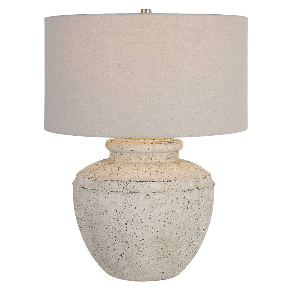 This sleek Artifact Table Lamp will add an elegant touch to your home. Crafted from ceramic with an aged stone finish and plated brushed nickel details, this lamp takes its inspiration from antique pottery. The light gray linen shade helps create a soft, warm ambiance.
