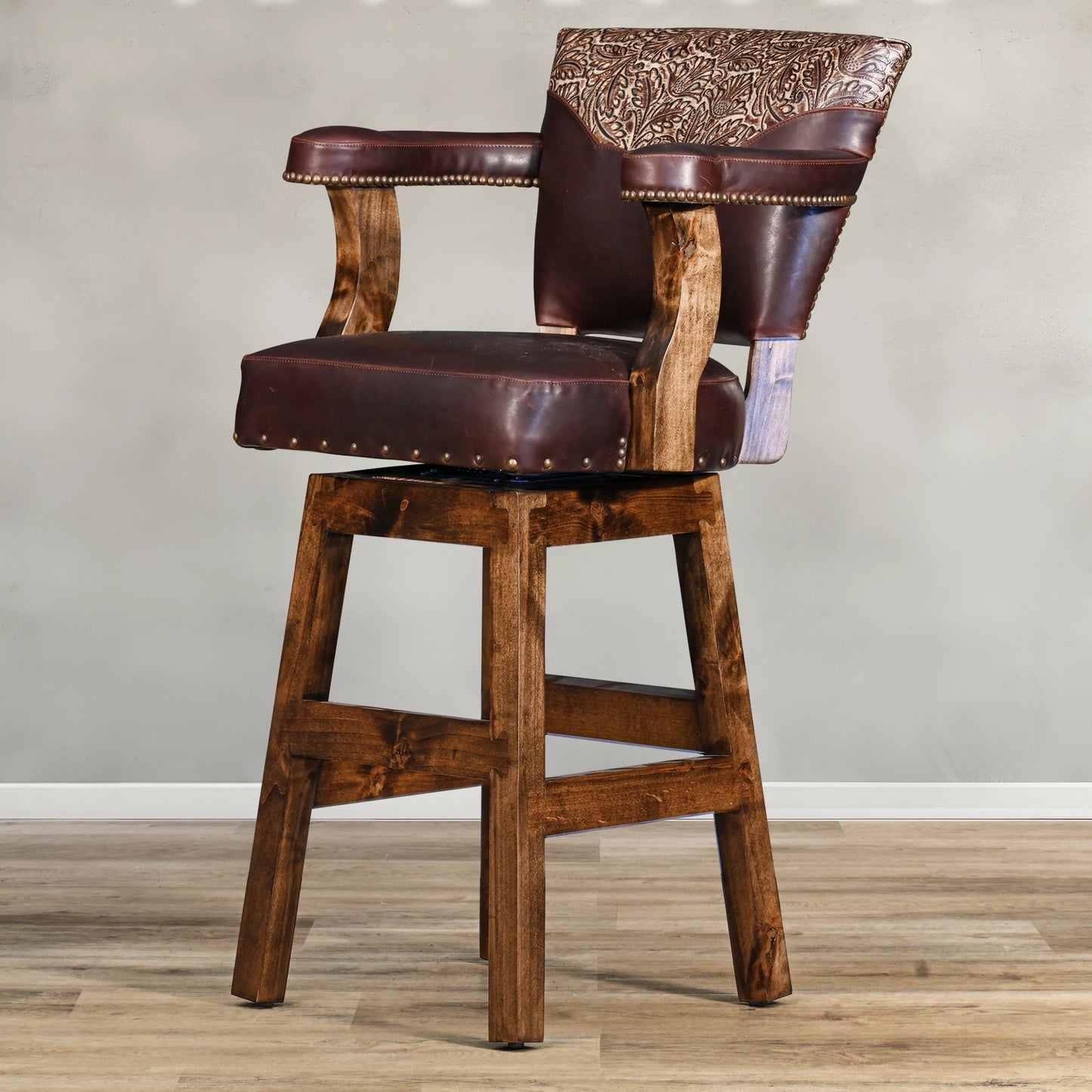 Experience rustic elegance with the Autumn Yoke Chisum Barstool. Its autumn tooled leather yoke and 100% top grain leather add a touch of sophistication, while the swivel feature offers convenience. Perfect for any bar or kitchen, this barstool combines style and function seamlessly.