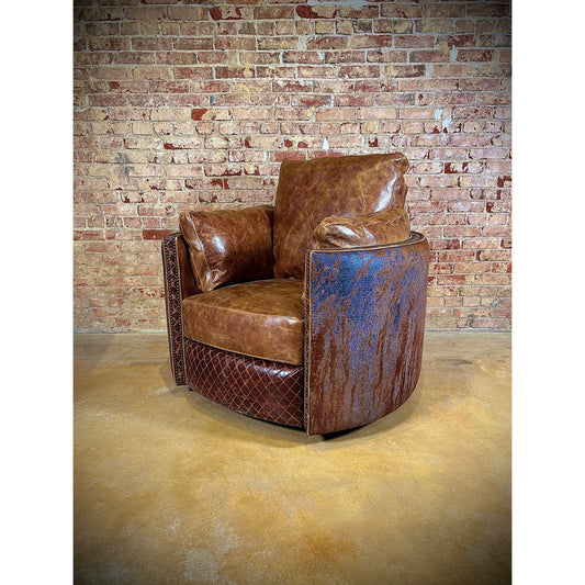 Experience ultimate comfort with our Cuddler Recliner. Made with top grain leather, our swivel chair not only provides luxurious relaxation but also cuddles your body for added support. Stay comfortable and cozy with this ultimate recliner. Add the perfect touch of Western luxury with the blue acid wash embossed croc cowhide leather wrapping the outside back of the recliner.  You are able to customize the leathers to create the perfect piece for your space.