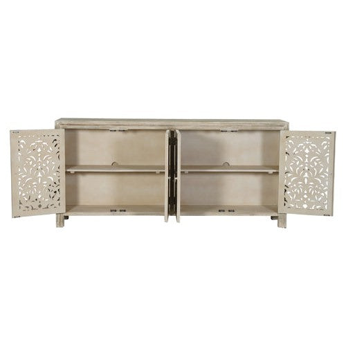 The Caprice Limestone grey 4 Door Console exudes expert craftsmanship with its hand-carved doors made of durable mango wood. This unique piece adds a touch of sophistication to any space, while providing ample storage space. Elevate your home decor with this stunning console.