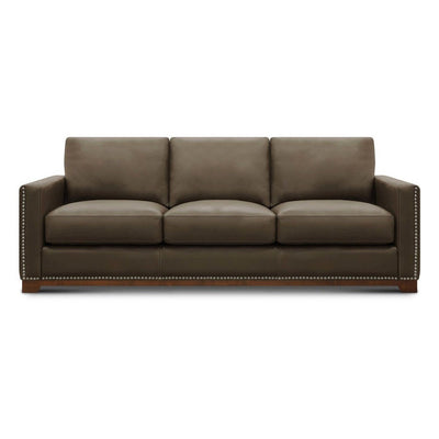 Brown leather sofa with nailhead trim and straight arms