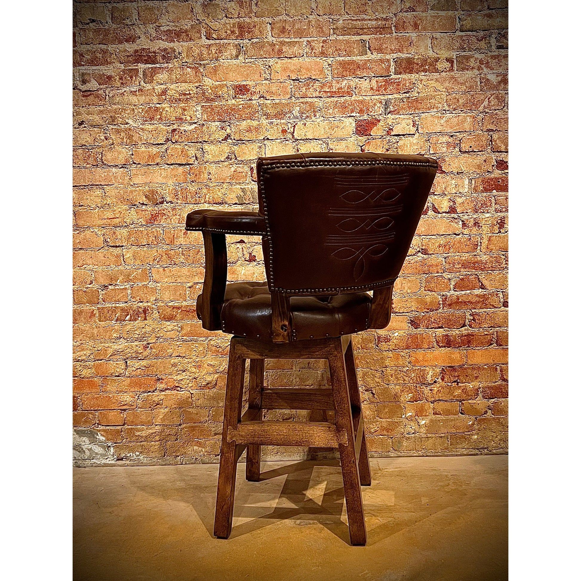 Elevate your seating experience with our Tufted Boot Stitch Chisum Barstool. The tufted seat and back provide both style and comfort, while the swivel feature allows for easy movement. The boot stitch on the outside back panel adds a touch of Western. Expertly crafted for a comfortable and stylish addition to any space.