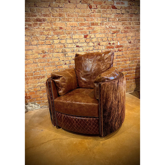 Experience ultimate comfort with our Cuddler Recliner. Made with top grain leather, our swivel chair not only provides luxurious relaxation but also cuddles your body for added support. Stay comfortable and cozy with this ultimate recliner.