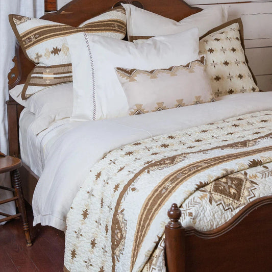 Discover classic Southwestern style with our Dakota Quilt Set, featuring Native American-inspired designs and a neutral earth-tone color palette. Relax with horizontal stripes, arrow motifs, and diamond patterns in shades of taupe, brown, and tan. Create a calming and tranquil bedroom atmosphere.