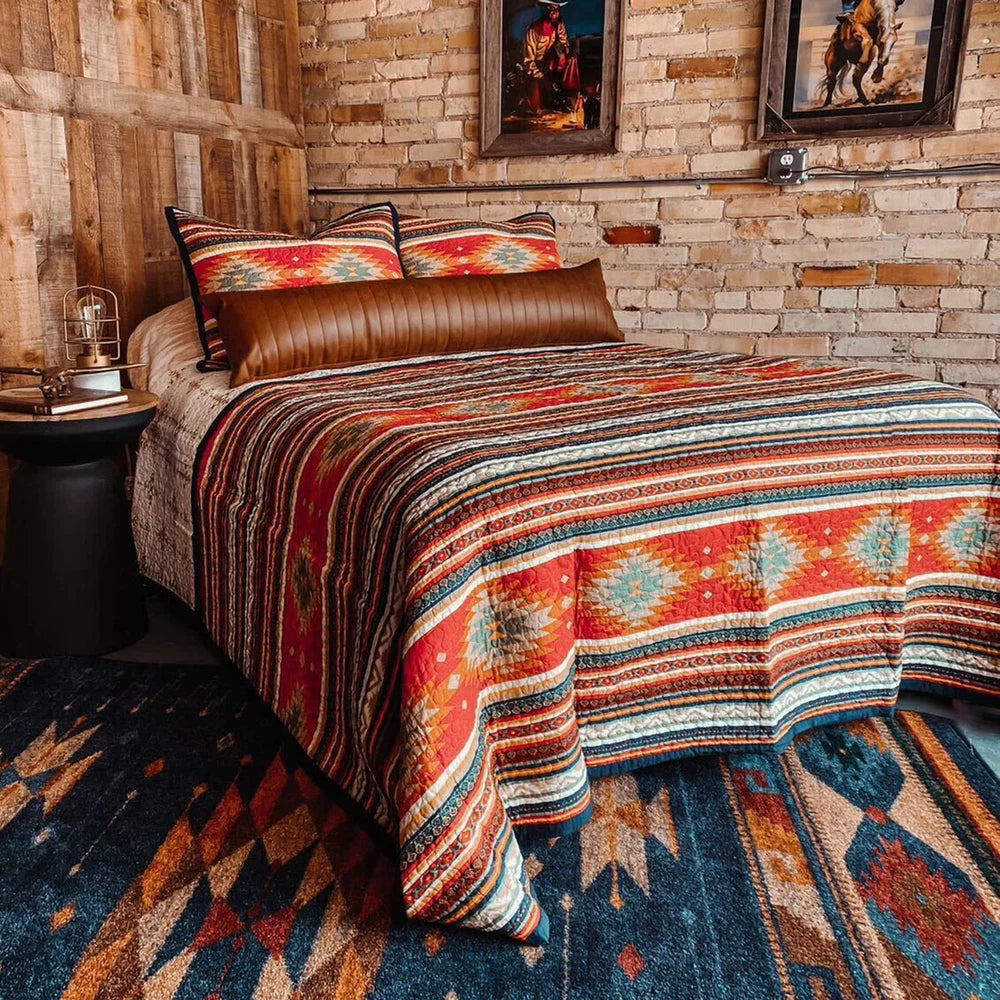 Transform your bedroom into a tranquil oasis with the Del Sol Quilt Set. This sophisticated modern twist on traditional Southwestern design features vibrant desert hues and superb Aztec-inspired patterns, framed by a navy flanged border for a bold, modern touch. Easily switch between two sides for added depth and a soothing, earthy look.