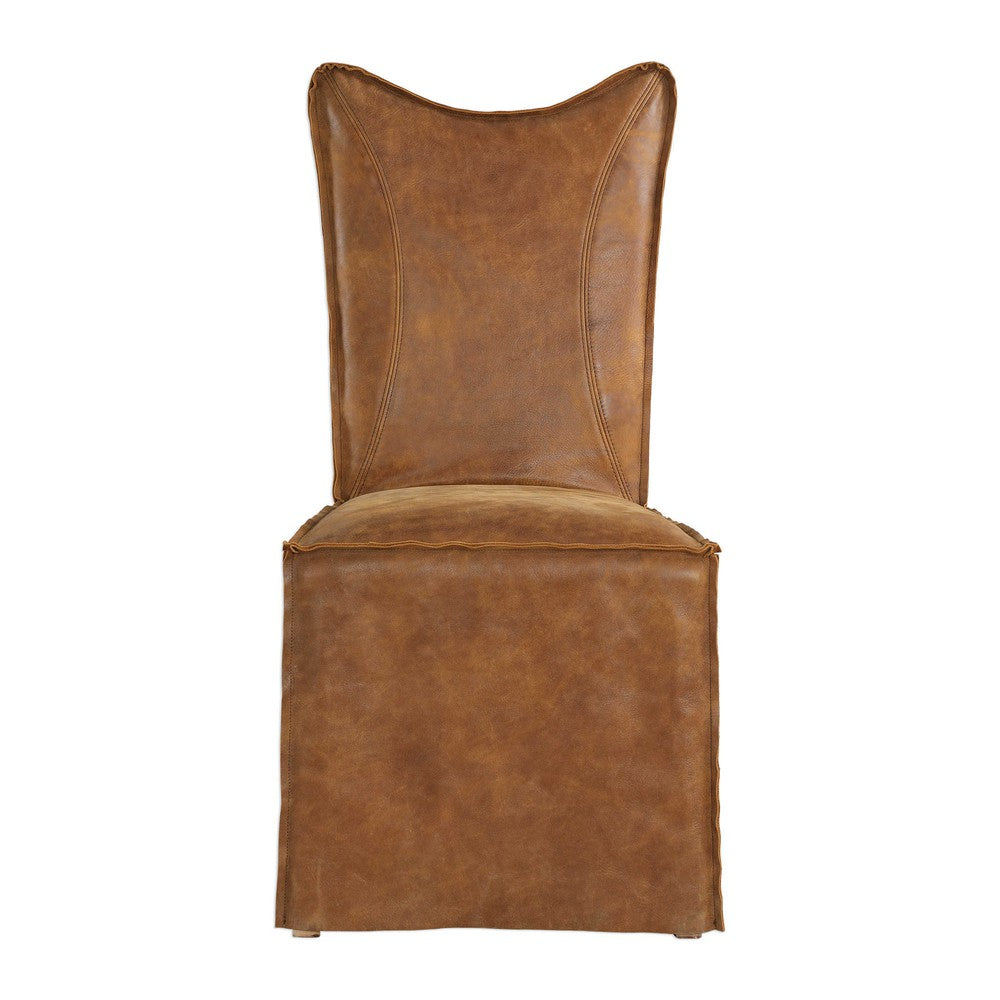 Thick top grain nubuck leather slipcover dining chair in a distressed hand sanded cognac with a tailored double stitched design and casual flange edges, featuring a button closure back. Because leather is a natural product, both texture and color will vary slightly from hide to hide and within the same hide. Slipcovers packaged separately. Seat height is 19". 