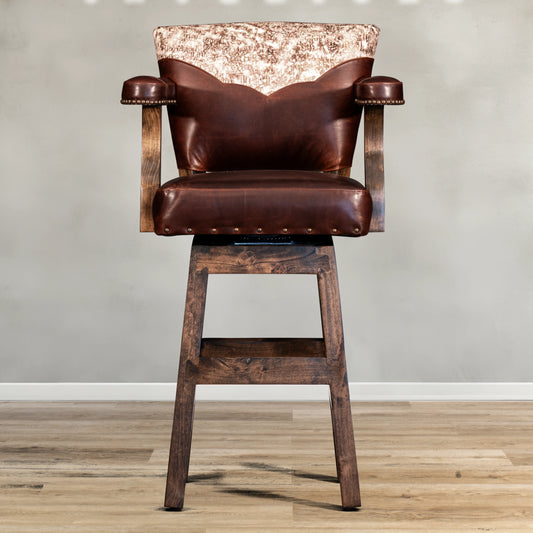 This western barstool features a top grain leather seat with an embossed leather yoke for added style and durability. Crafted with expert precision, this barstool offers a luxurious experience while also providing long-lasting comfort. Upgrade your seating with our high-quality western barstool.