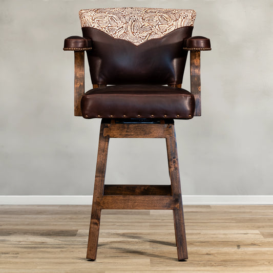 Experience ultimate comfort and style with our Floral Yoke Chisum Barstool. Made with high-quality leather and accented with nail detailing, this stool also boasts an embossed leather yoke and swivel feature. Perfect for any space, it offers both durability and luxury.