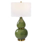 This Gourd Table Lamp is an elegant piece worthy of any home. Crafted with a timeless gourd shaped ceramic base, it features a moss green glaze accented with lightly antiqued brass plated details. The round drum shade is made from white linen fabric, giving the lamp a soft and inviting feel. Due to the unique nature of fired glazes on ceramic lamps, each lamp has an individual finish.
