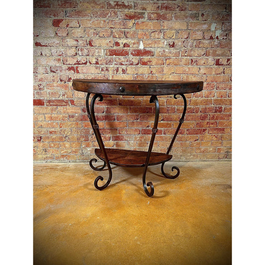 This Half Round Table is expertly crafted with a hand forged iron base, providing exceptional durability and a unique design. Its solid wood top adds a touch of natural beauty, while the wood shelf at the bottom offers additional storage space. A perfect choice for both style and function.