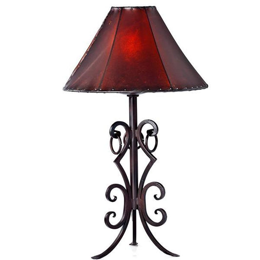 This timeless hand forged iron table lamp is a perfect blend of rustic charm and modern aesthetics. It's durable construction makes it a great addition to any room. The natural black finish complements any decor, indoors or outdoors.