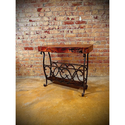 Experience the unique combination of industrial and rustic style with the Copper Magazine Table. Crafted from hand-forged iron and hammered copper, this side table is sure to add a modern, functional touch to any room. Its ample surface space provides the perfect place for your favorite magazine or book.