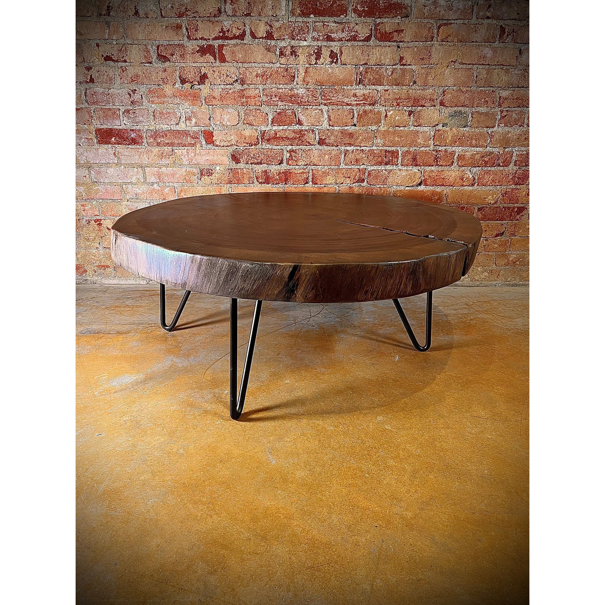 Elevate your living space with our Costa Parota Wood Coffee Table. Crafted with a sturdy iron base and a gorgeous parota wood top, this table brings a touch of nature into any room. With its live edge design, each piece is truly one-of-a-kind. Experience the beauty and durability of parota wood.    Ships in approximately 4 weeks.