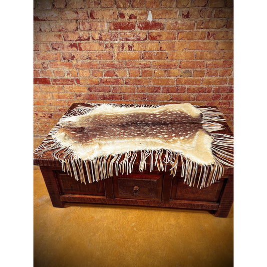 Enhance the aesthetic of your coffee table or dining table with our premium Fallow Deer Hide Table Topper. Made from luxurious fallow deer hide, this topper features a stunning leather fringe detail for added elegance. Perfect for adding a touch of sophistication to any table setting.  Ships within one week.
