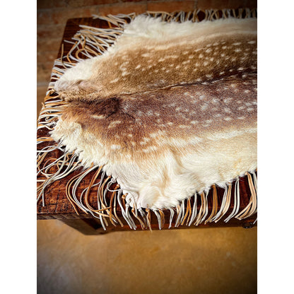 Enhance the aesthetic of your coffee table or dining table with our premium Fallow Deer Hide Table Topper. Made from luxurious fallow deer hide, this topper features a stunning leather fringe detail for added elegance. Perfect for adding a touch of sophistication to any table setting.  Ships within one week.