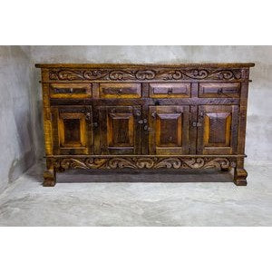 This Regency Buffet is crafted with hand-carved solid wood and features doors and drawers for ample storage. Finished in a distressed turquoise hue, it adds an elegant touch to any dining area.