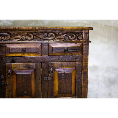 This Regency Buffet is crafted with hand-carved solid wood and features doors and drawers for ample storage. Finished in a distressed turquoise hue, it adds an elegant touch to any dining area.