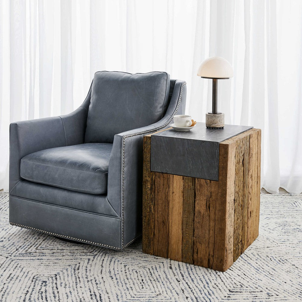 The Jonah Side Table is a unique fusion of rustic and refined. Crafted from naturally-stained reclaimed pine and topped with honed black marble, this piece is sure to add character to any room. Its variegated marbling and veining give it a truly distinctive look, while its solid wood construction ensures a lifetime of stability that will only improve with age.