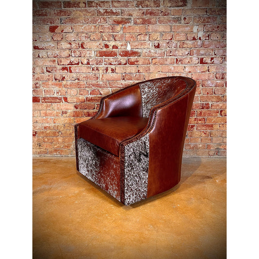 Experience ultimate comfort in style with the Longhorn Swivel Leather Barrel Chair. Made with top grain leather and hair on hide accents, this chair boasts a western flair with its nailhead trim and 360 degree swivel feature. Get ready to relax in extreme comfort and add a touch of rustic charm to your space!