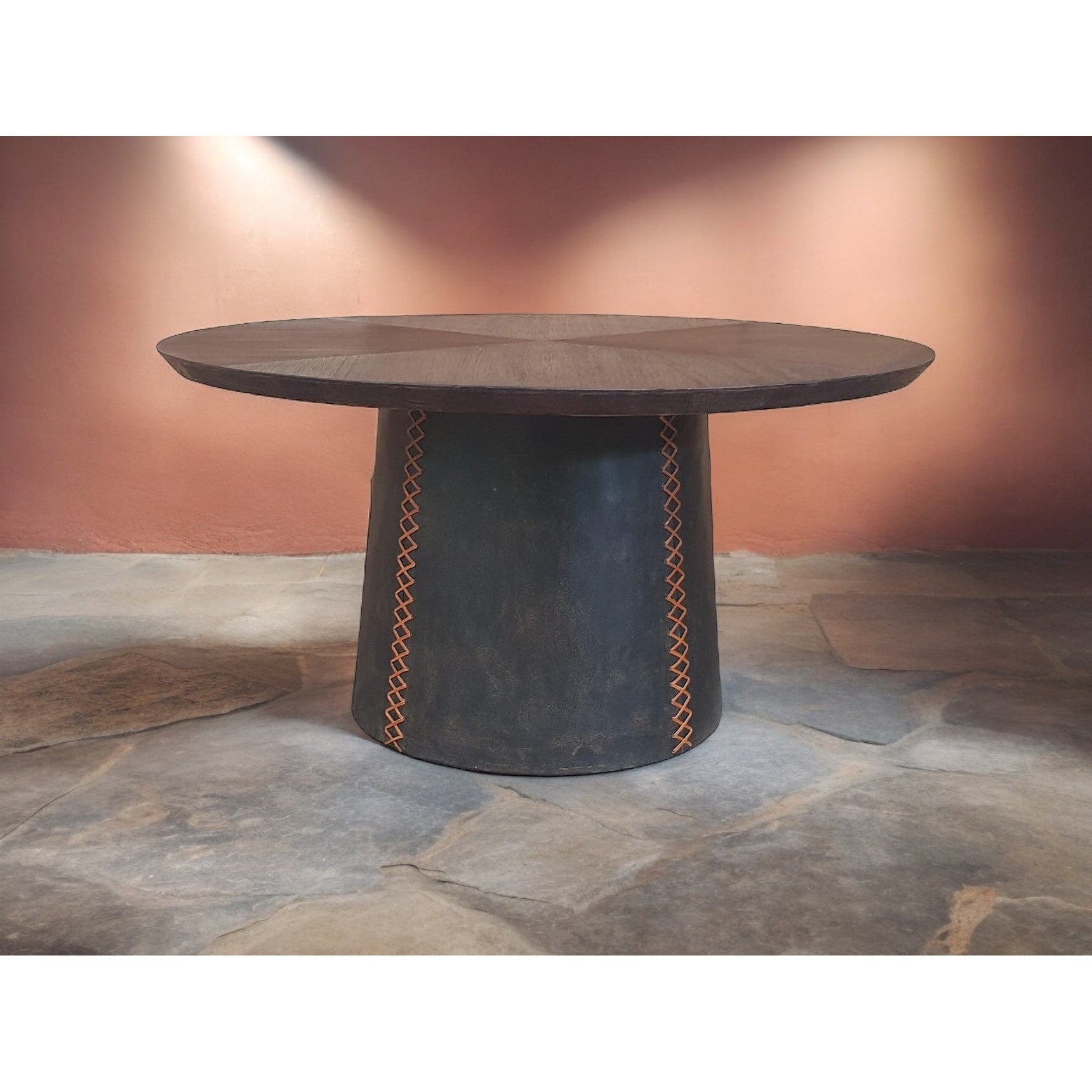 Expertly crafted with a solid wood top and upholstered leather base, the Lucca Round Dining Table is both stylish and durable. The stitching on the base adds a touch of sophistication, making it the perfect addition to any dining room. Enjoy a high-quality dining experience with this elegant and sturdy table.