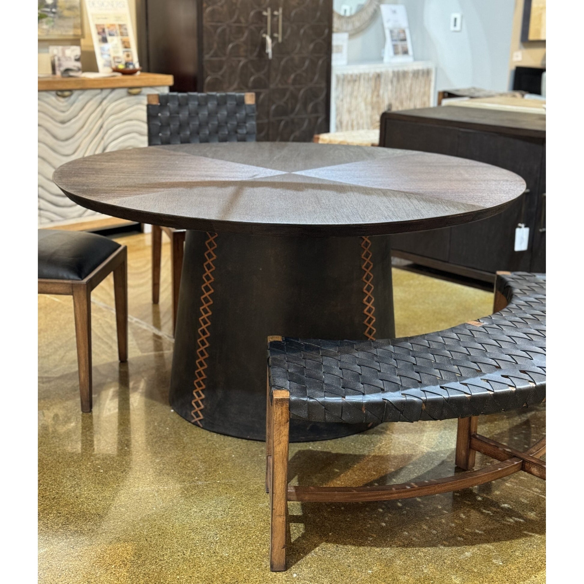 Expertly crafted with a solid wood top and upholstered leather base, the Lucca Round Dining Table is both stylish and durable. The stitching on the base adds a touch of sophistication, making it the perfect addition to any dining room. Enjoy a high-quality dining experience with this elegant and sturdy table.