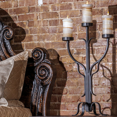 Romantic western bed with curved carved headboard and antiqued wood finish in an intimate bedroom