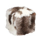 This Tibetan Lamb Pouf is a luxurious, solid wood cube wrapped in plush foam and soft tibetan lamb, perfect for extra seating in a living room or as a vanity stool. Its versatility makes it a great addition to any home. It can also be used as an ottoman!