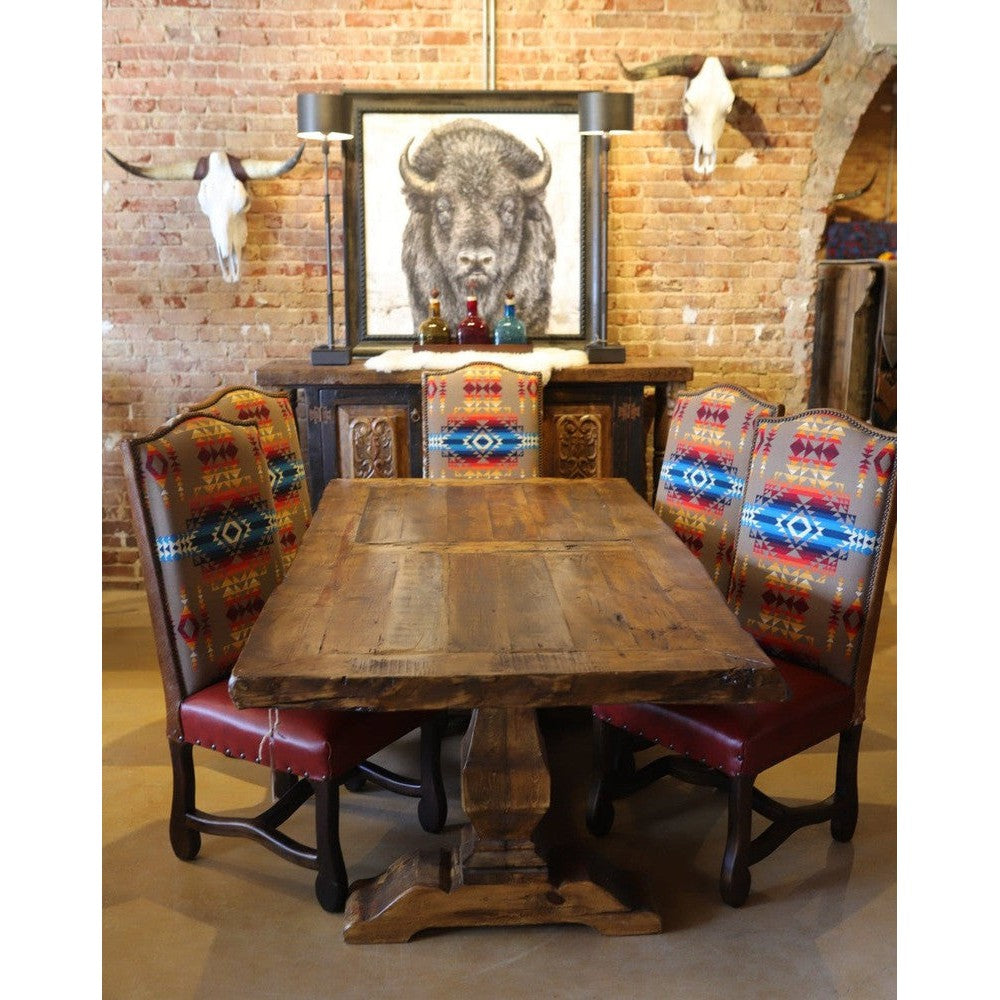 This classic trestle dining table features solid reclaimed wood, giving it a distinct rustic elegance. The distressed finish adds a timeless look to this piece, making it a timeless addition to your home.