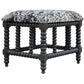 Ranch and modern lodge styles converge to create this plush, upholstered bench. The cushioned seat is wrapped in a charcoal gray and white faux cow hide, accented by a matte black stained base turned from solid plantation-grown mahogany wood
