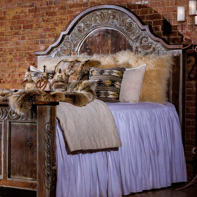 Refined western wood bed frame with paneled headboard in a softly lit bedroom