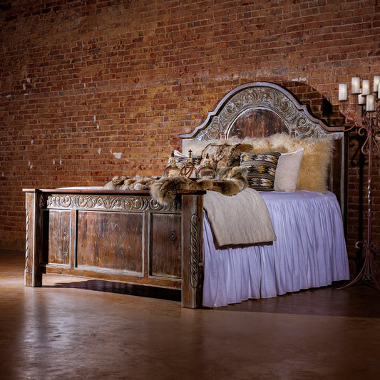 The Regency Wood Bed Frame adds a sophisticated, traditional, and rustic style to any bedroom. Crafted from hand-carved, reclaimed wood with a curved top and a hand-distressed cream wash, this classic piece of bedroom furniture is sure to elevate any room.
