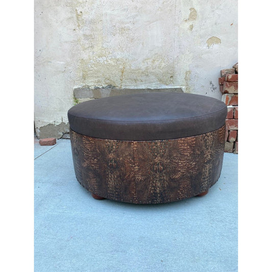 This luxurious ottoman is guaranteed to be the perfect accent to any room in your home. Crafted from top grain leather and stamped with an alligator skin pattern, it can serve as a stylish coffee table or be set up as a statement piece ottoman.