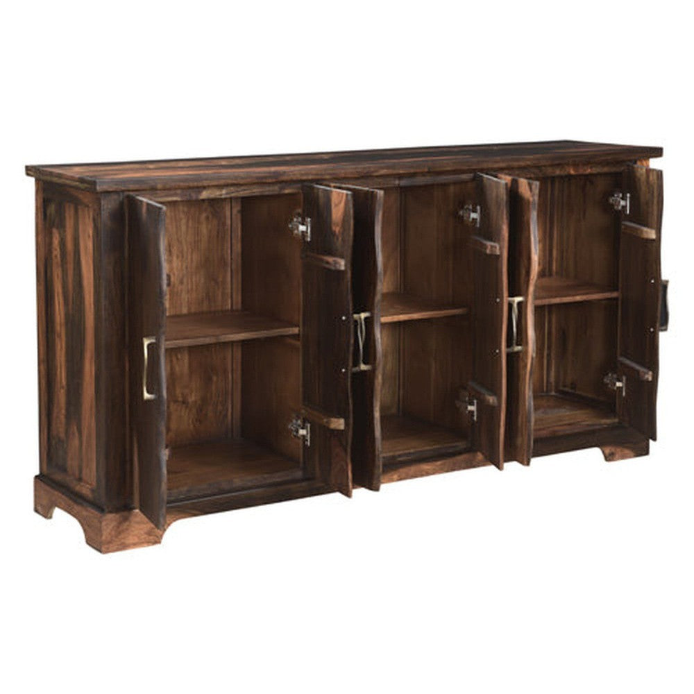 The Riviera Sideboard is an elegant piece of furniture with a refined dark finish. It features a live edge wood design and curved metal accents that add a modern touch. Perfect for stylishly stowing away your belongings, this sideboard is sure to elevate any living space.