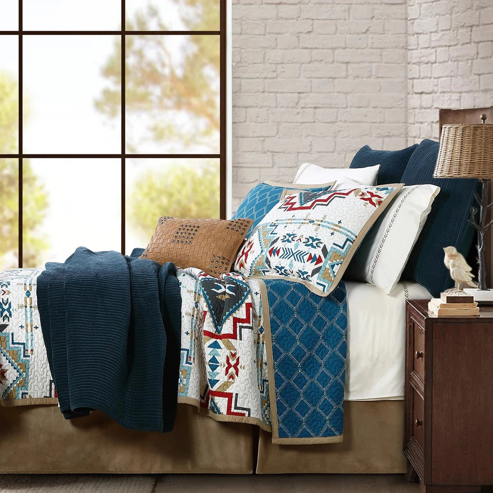Bring a vibrant Southwestern touch to your bedroom with the Spirit Valley Quilt Set. Crafted in a palette of red, teal, taupe, and navy against a vintage white background, the Aztec-inspired pattern is reversible for an elegant and classic alternative. Enjoy the perfect balance of style and comfort.