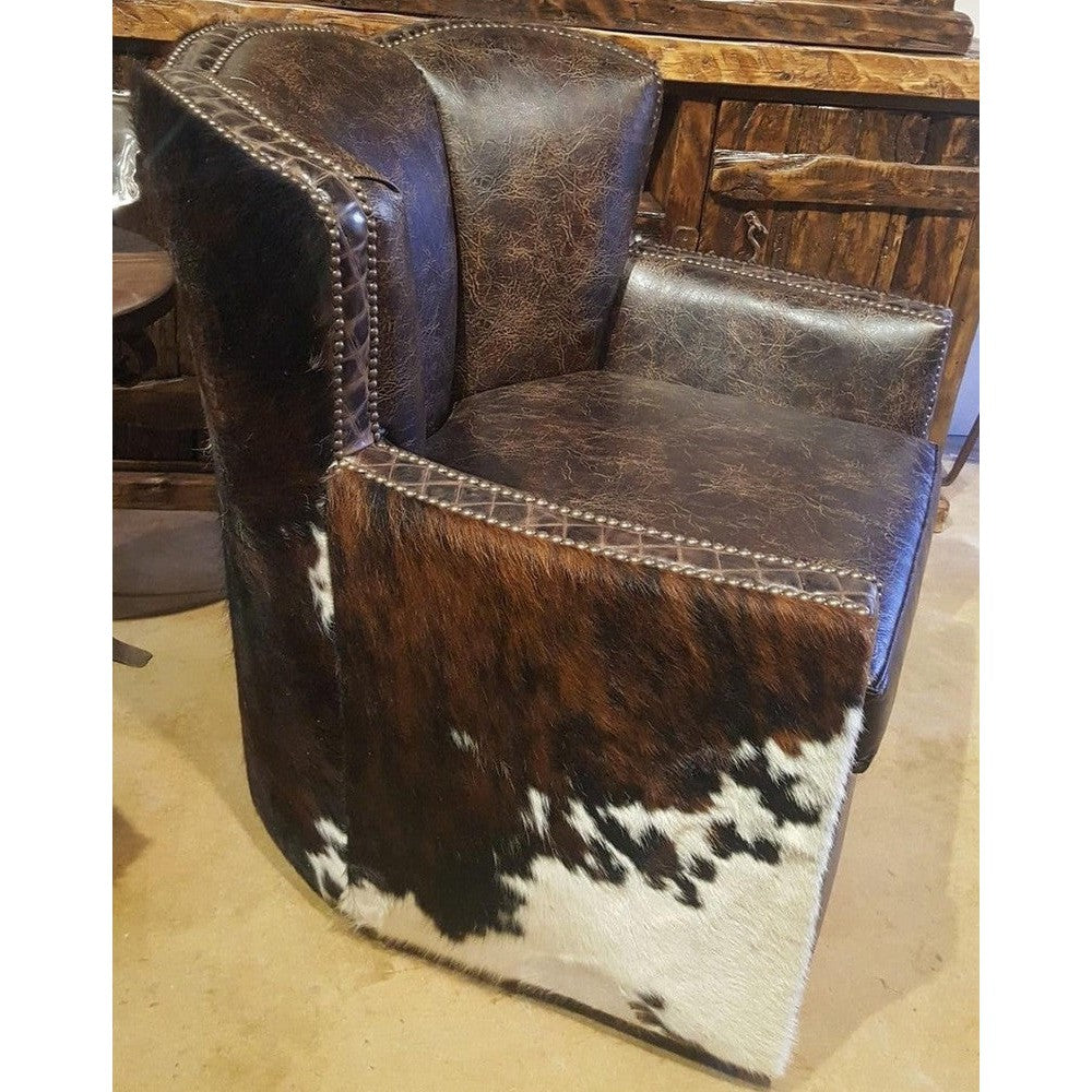 This Standard Cowboy Conch Chair is designed for maximum comfort and luxury. It features a large swiveling seat upholstered in top grain leather with a luxurious diamond stitch leather trim and tri colored cowhide. Exquisite craftsmanship and superior materials make this chair an ideal choice for any room.