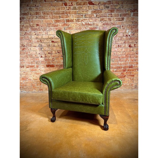Crafted with top grain leather, the Stetson Leather Bootstitch Wingback Chair features a classic bootstitch design, elegant nailhead trim, and traditional rolled arms. Its sturdy claw foot adds durability and style to any room. Sit back and relax in this timeless and luxurious piece.