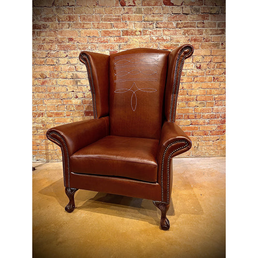 Step up your interior design game with the Stetson Wingback Chair. Crafted with a distinctive boot stitch and elegant wingback design, this chair exudes rustic charm. Elevate your space with a touch of sophistication and comfort.