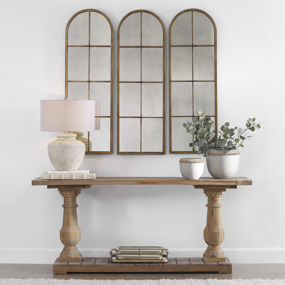The Stratford Console Table is crafted from sturdy, salvaged fir lumber with a hand-turned baluster. Its sun-faded and distressed patina is complemented by a stony gray wash, creating a unique, rustic look. Each piece is solid wood, ensuring temperature and humidity changes won't affect its stability.