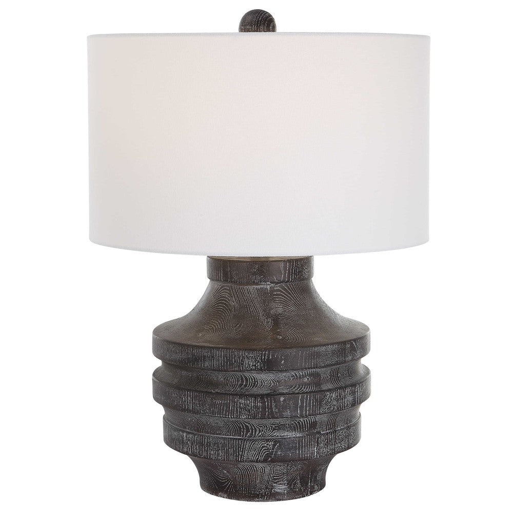 The perfect rustic accent, the Timber Table Lamp brings the outdoors in with a carved wood look in a transparent black stain with warm undertones and a light white glaze accentuating the faux wood grain. The hardback drum shade is covered in a white cotton fabric.