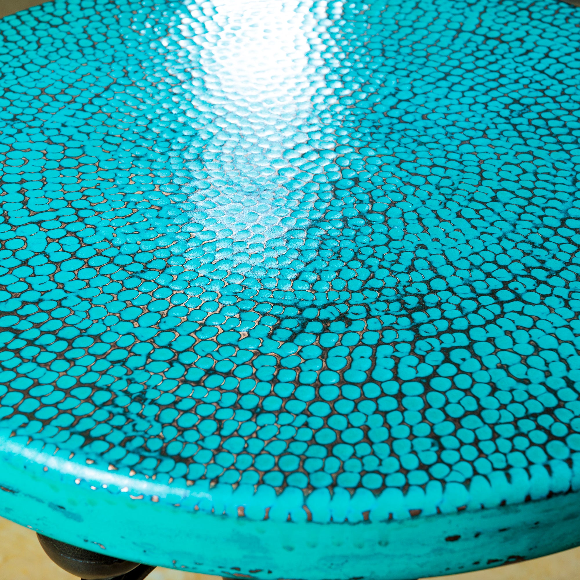 Detail of the hammered turquoise copper tabletop on The Azul Mesa Accent Table